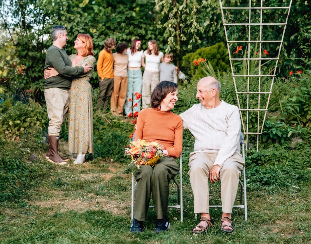A group of people sitting in chairs in a garden.