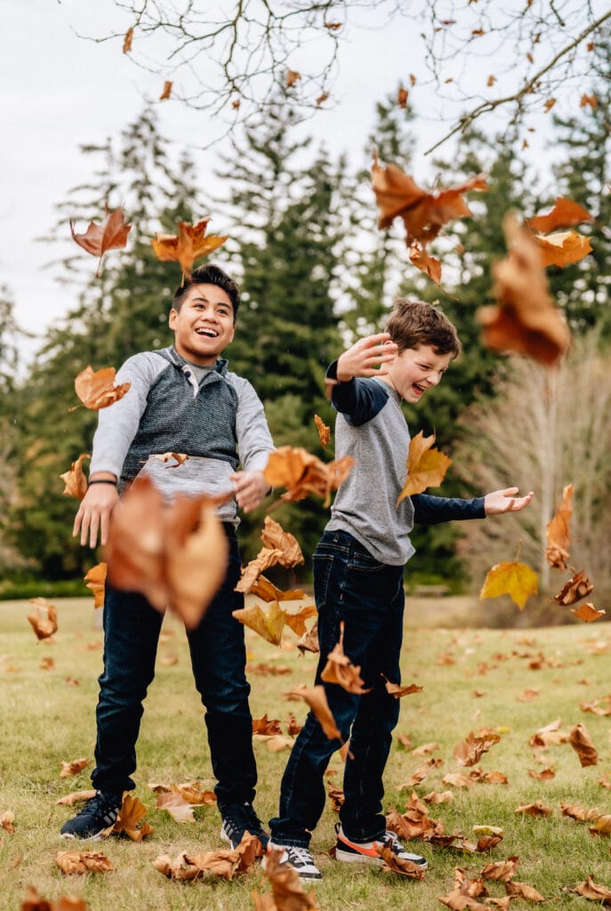 Two boys play in the Fall leaves at Buck Lake Community Park